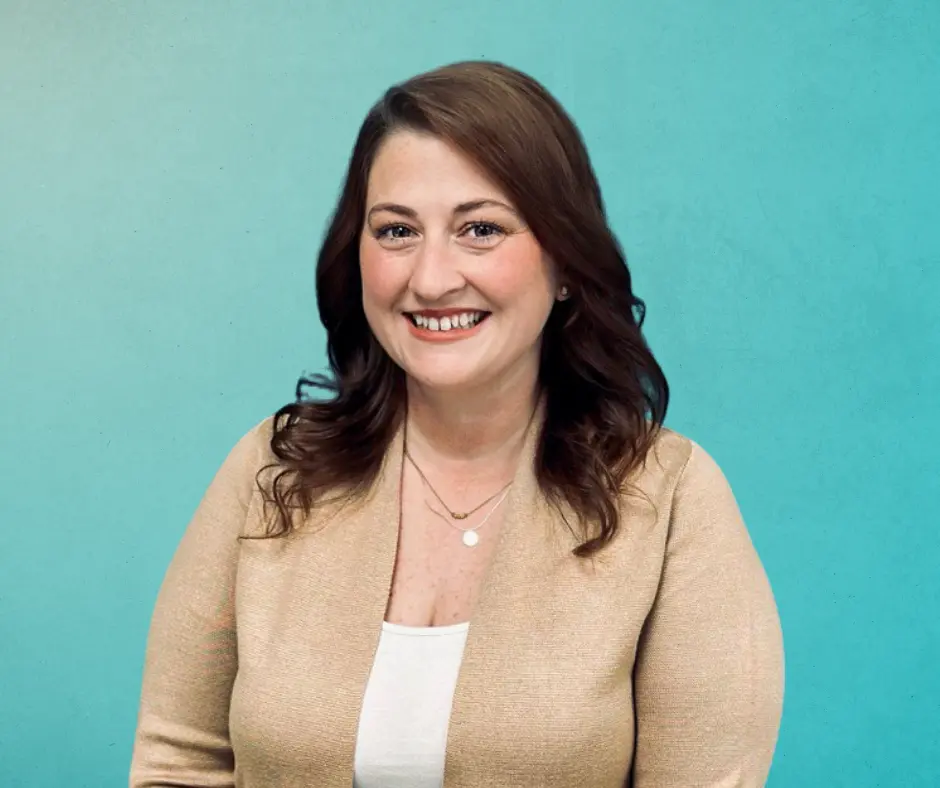 Jessica Brownfield, DVM smiling on a teal gradient background