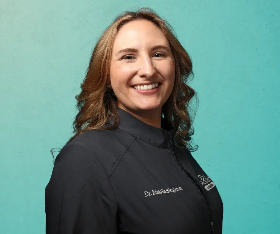 Natalie Singleton, DVM - AcutePet Urgent Care Associate Veterinarian smiling on a gradient teal background